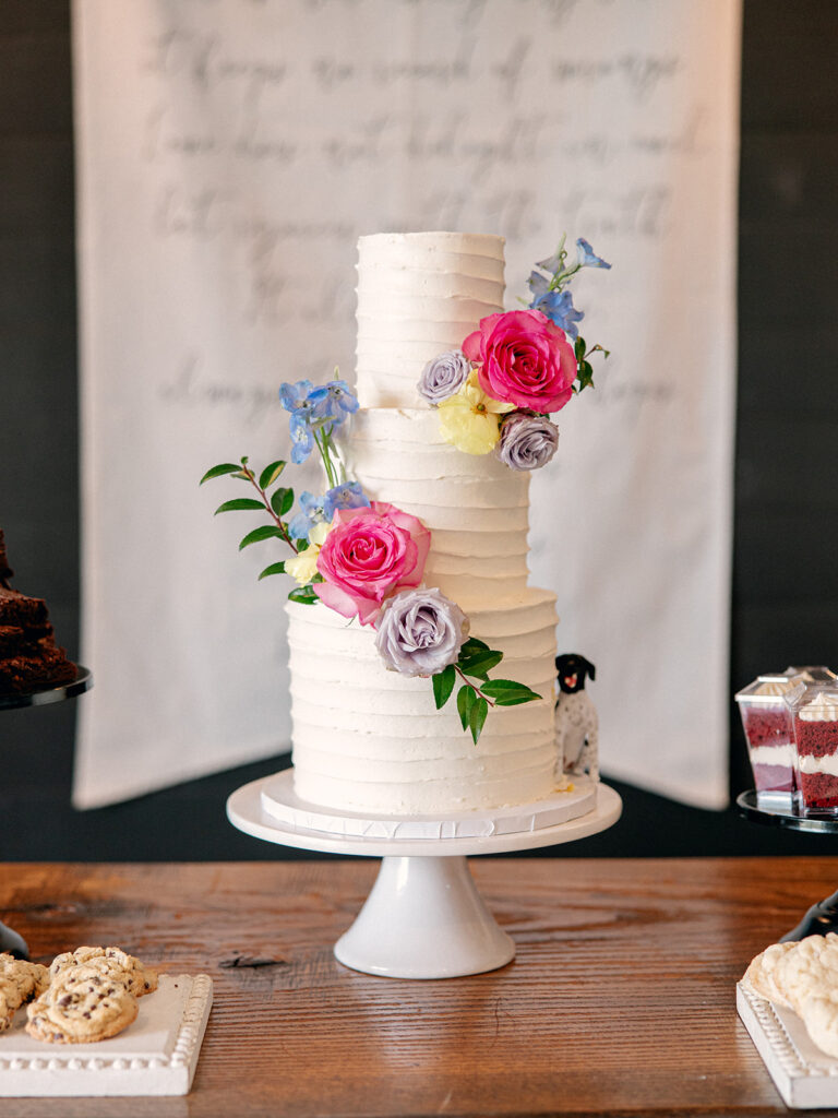 3 tier wedding cake with flowers on the cake