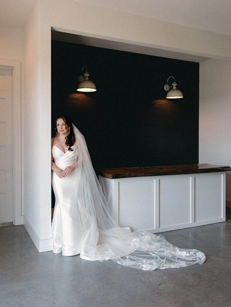 Bride gazing out the window during bridal portrait session