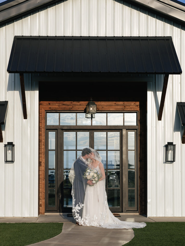 Bride and Groom portraits during golden hour in front of the wedding venue at Davis and Grey Farms